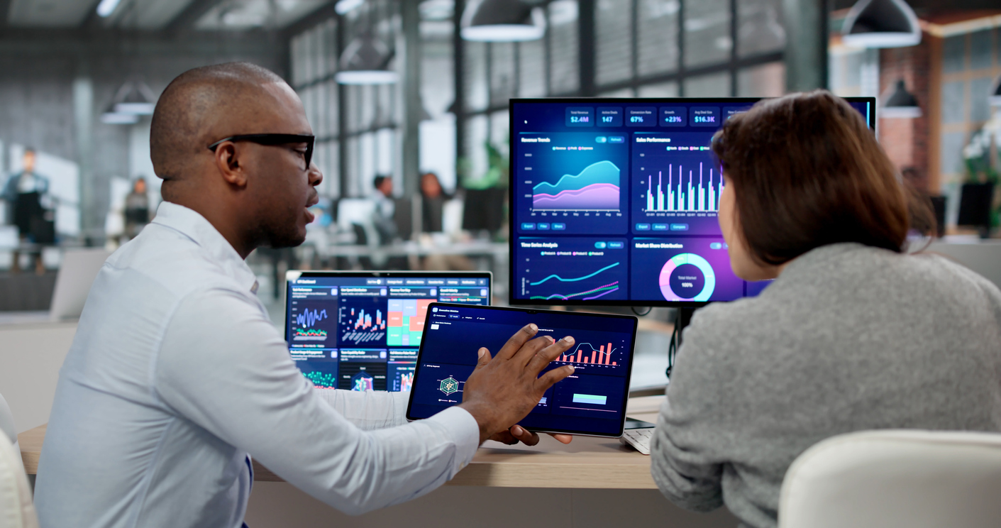 Bolton data consultants reviewing analytics dashboards on screen